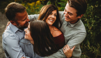 Family with older kids in a group hug